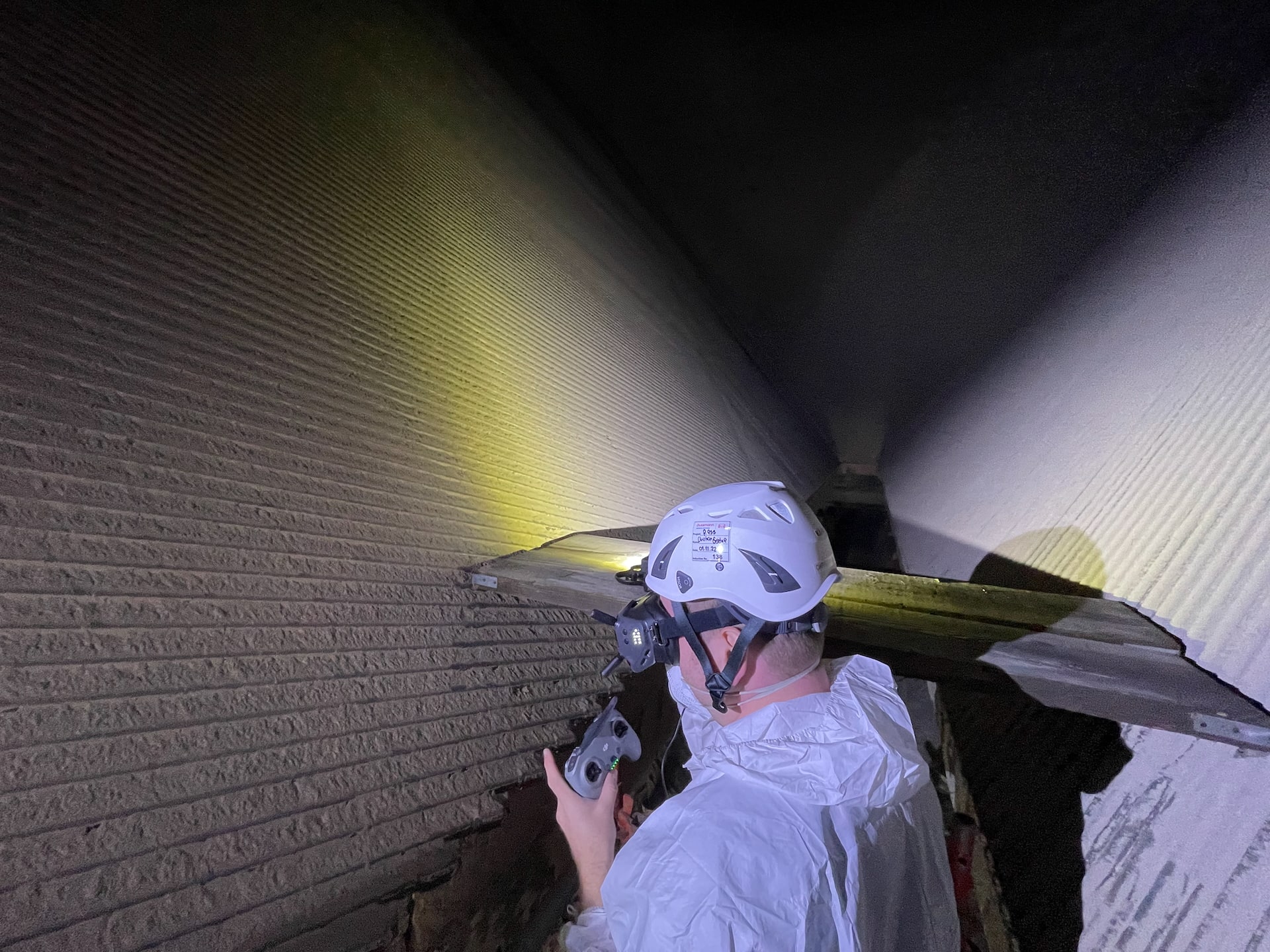 Drone pilot with video goggles during boiler inspection in coal power plant